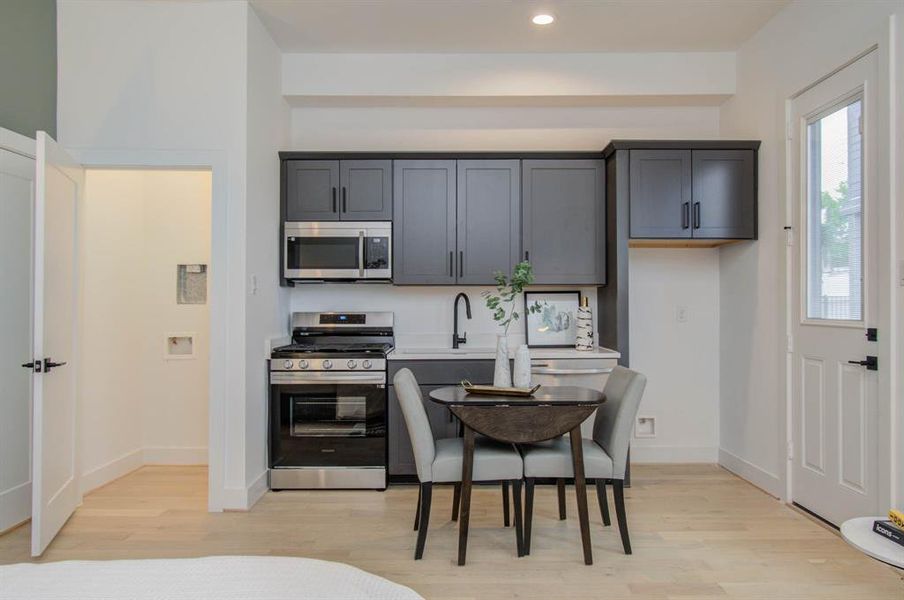 First level bedroom is its own studio apartment that features a private laundry closet, full sized gas stove, vented microwave, full-sized sink, full-sized dish washer and a fridge connection.