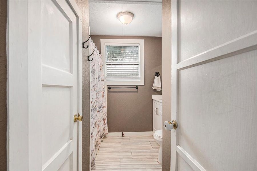 Guest bath with tub/shower combo and tile floors.