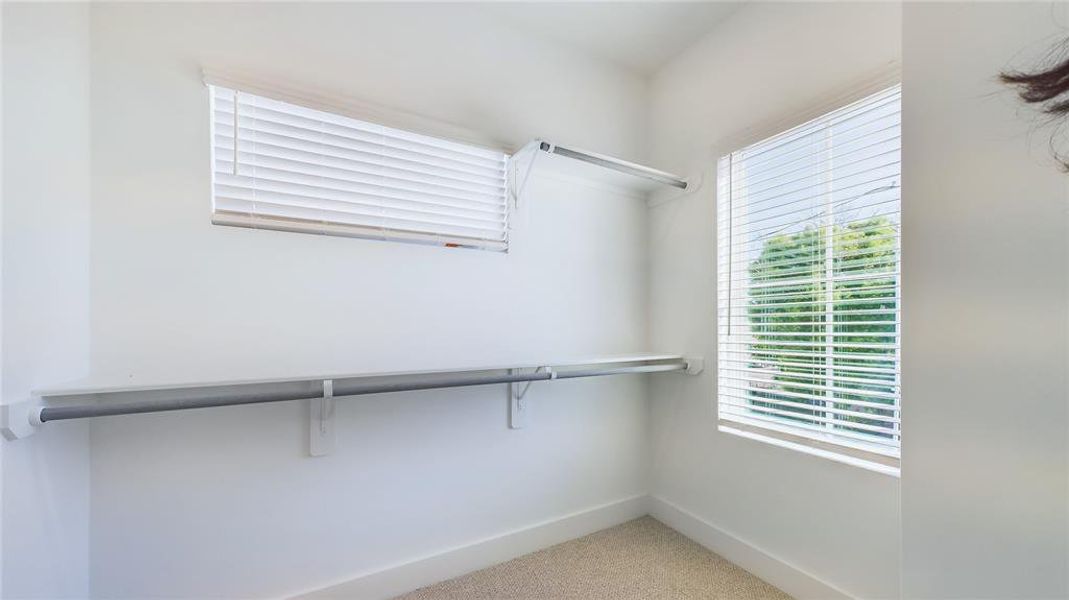 Primary bedroom walking in closet