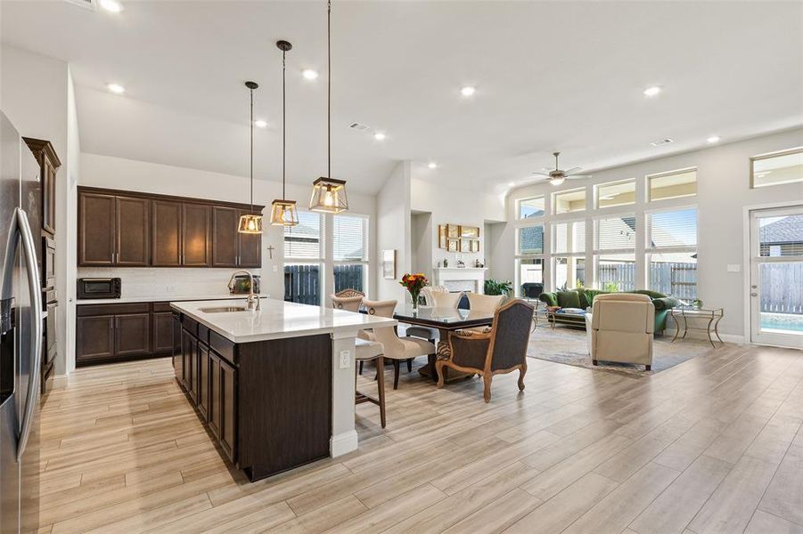 Experience seamless indoor-outdoor living in this bright and modern open-concept space, enhanced by abundant custom windows that bathe the kitchen, dining, and living areas in natural light.