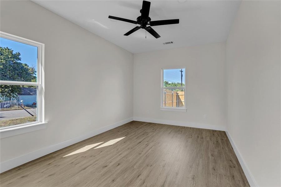 Unfurnished room with ceiling fan and light hardwood / wood-style flooring