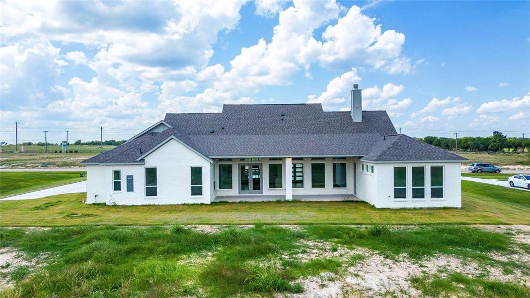 Rear view of house with a lawn