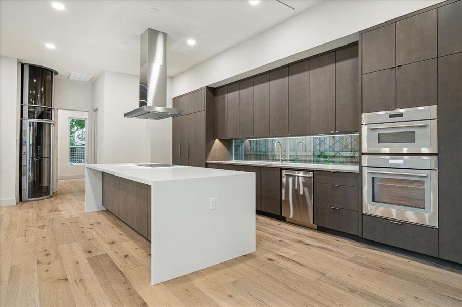 Sophisticated modern designed open kitchen exudes lots of natural light.