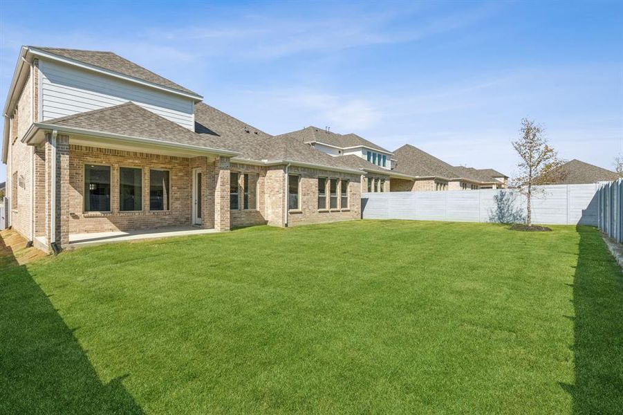 Back of house featuring a patio area and a lawn