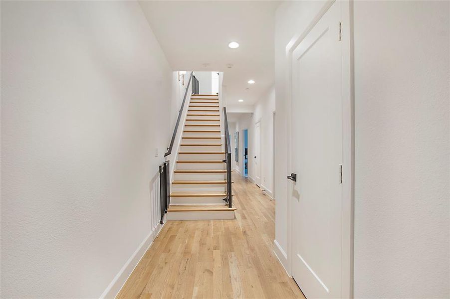 Stairs with light hardwood / wood-style flooring
