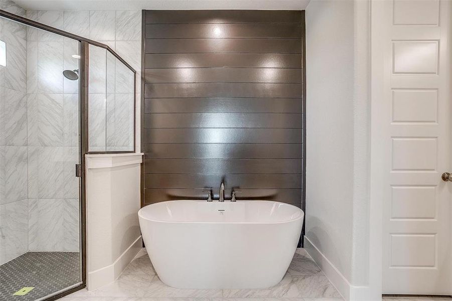 Bathroom featuring shower with separate bathtub and tile patterned floors