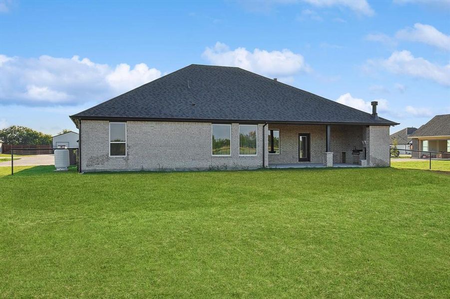 Back of house featuring a yard and a patio area