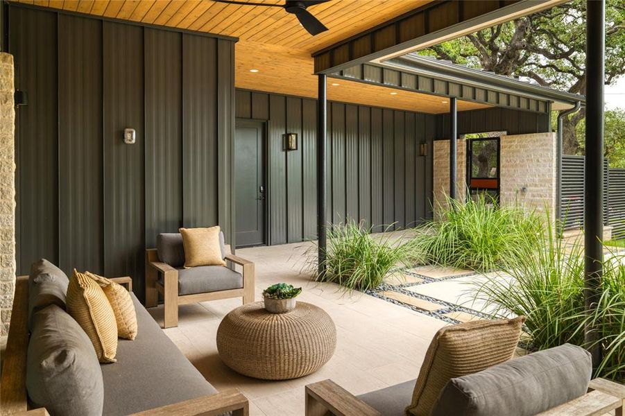 The outdoor lounge sits just outside the living room, accessible by an expansive four-part Western sliding door, making for true indoor-outdoor living.