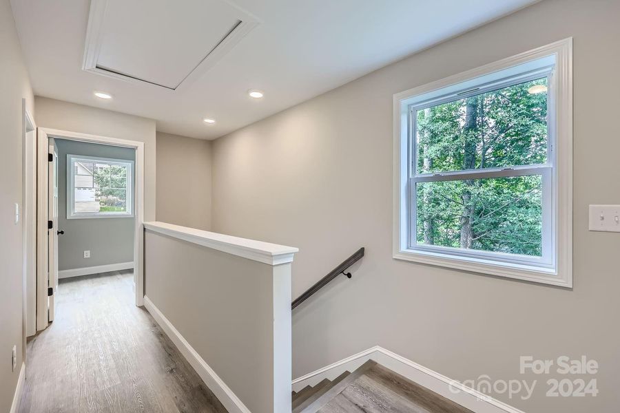 Upstair hallway leads to laundry room and primary suite.