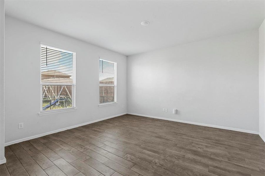 Unfurnished room featuring dark wood-type flooring