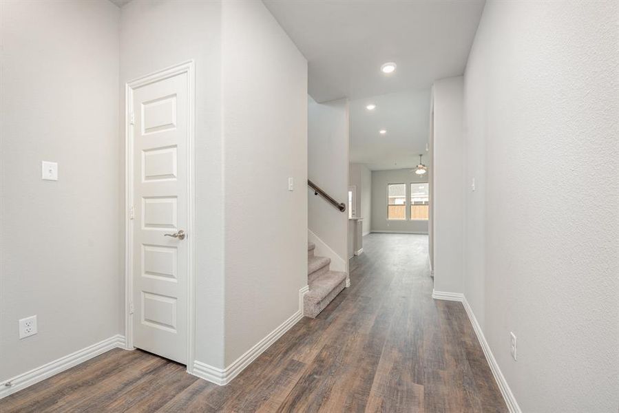 Corridor featuring dark wood-type flooring