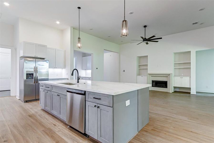 The oversized sink with an oil rubbed bronze faucet overlooks the family room for an all-inclusive feel.