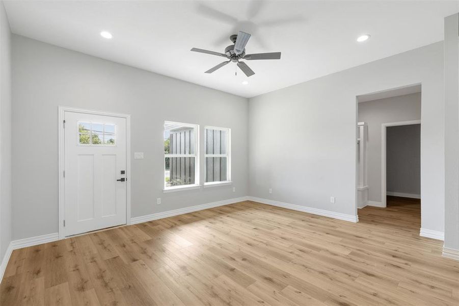 Kitchen featuring vaulted ceiling, built in microwave, dishwasher, sink, and light wood-type flooring