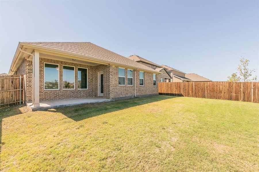 Back of house featuring a yard and a patio