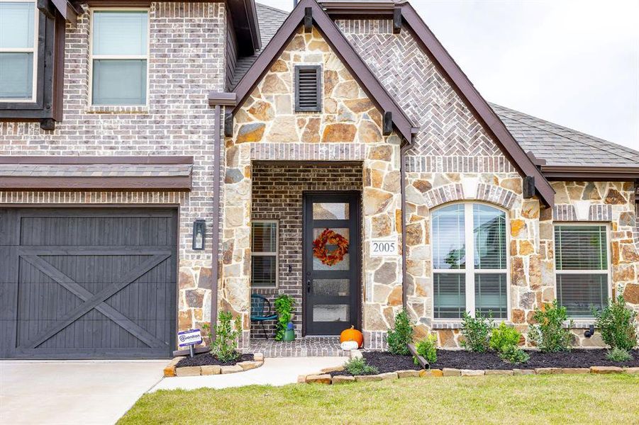 Tudor house featuring a 3 car garage