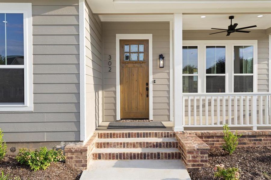 Doorway to property featuring ceiling fan