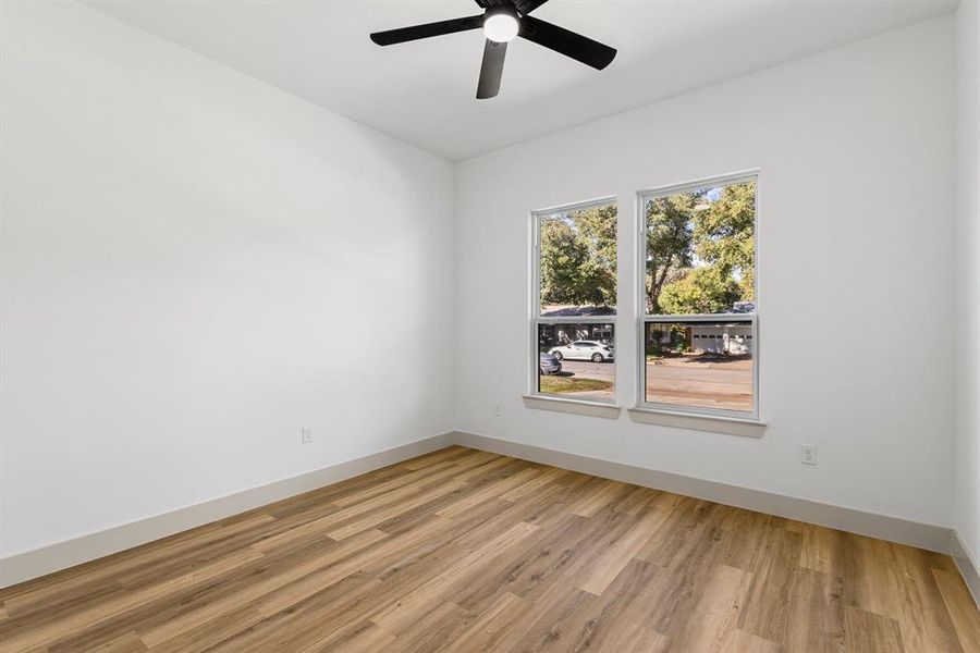 Unfurnished room with light hardwood / wood-style flooring and ceiling fan