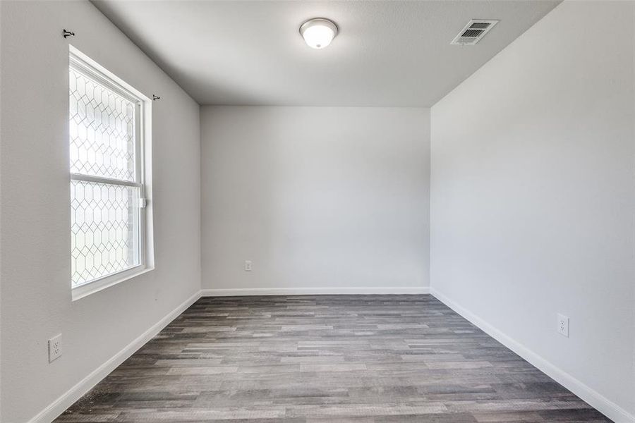 Unfurnished room featuring hardwood / wood-style flooring