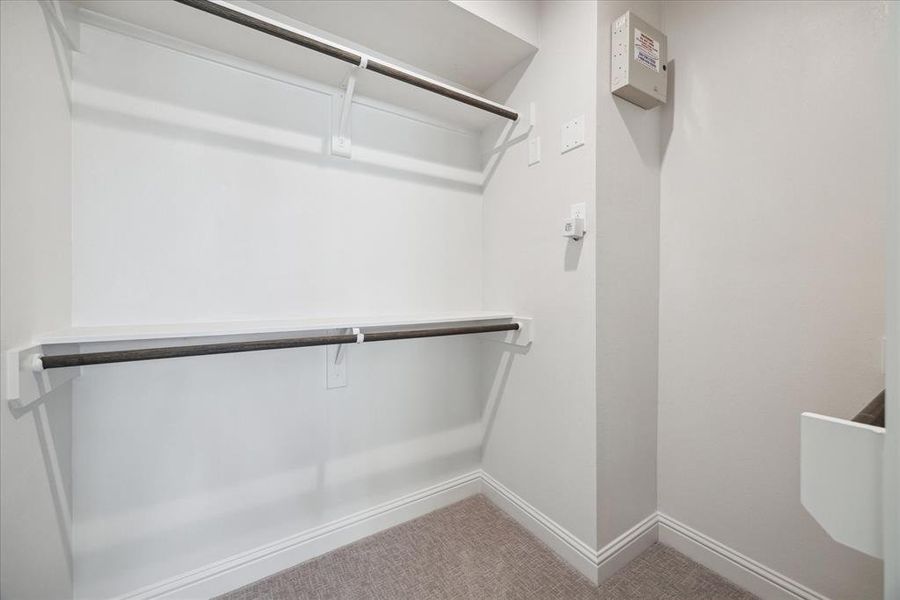 Additional walk-in closet within the primary bathroom, offering extra storage and organization options.