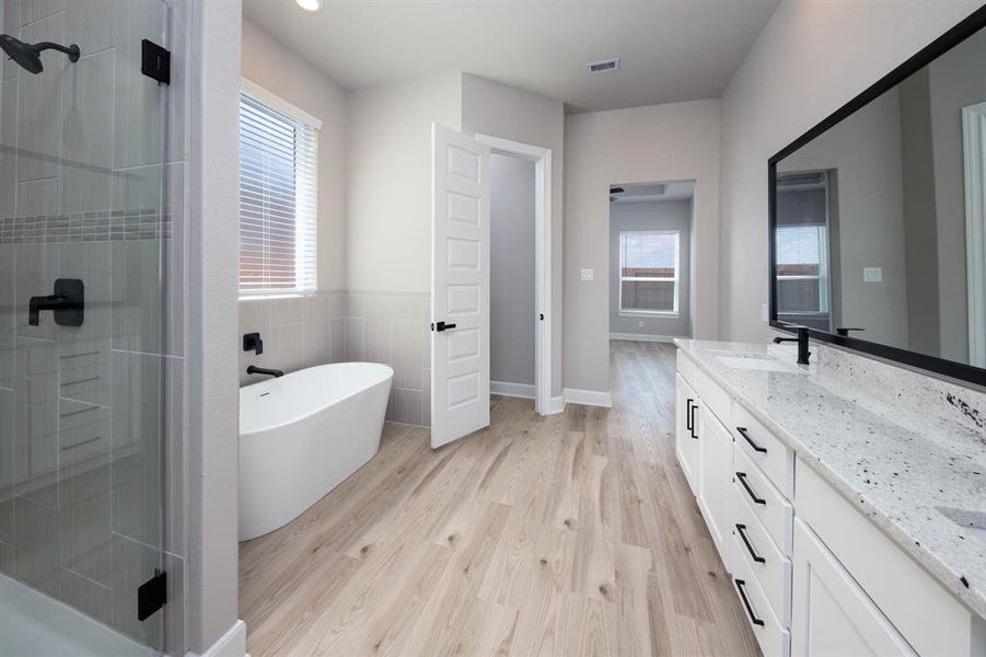 The master bedroom offers an incredible bathroom with a standalone tub, a dual-sink vanity, a sizeable shower and an impressive walk-in closet.