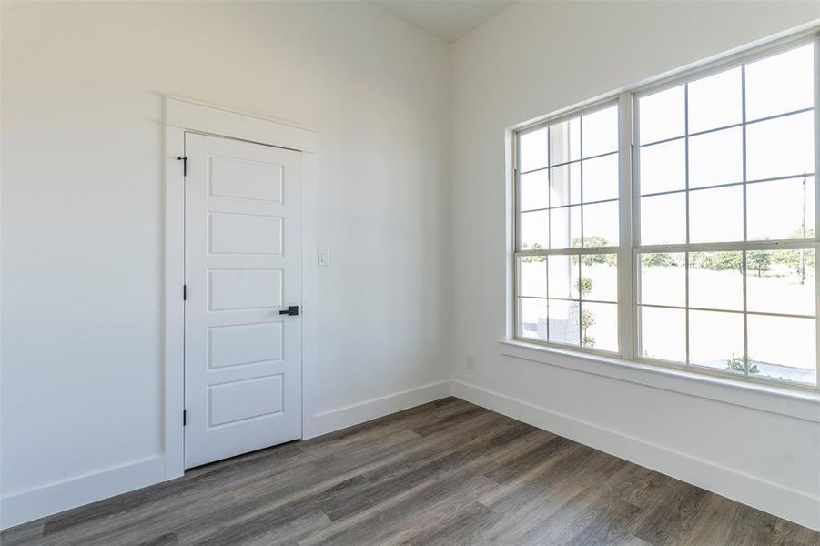 Empty room with dark wood-type flooring