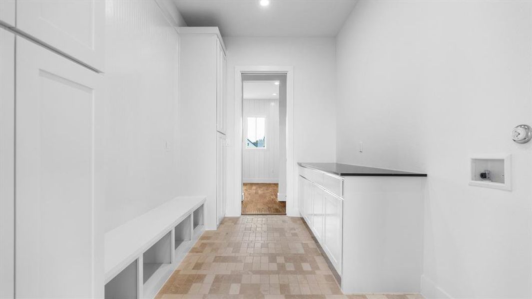 Mudroom with light tile patterned floors