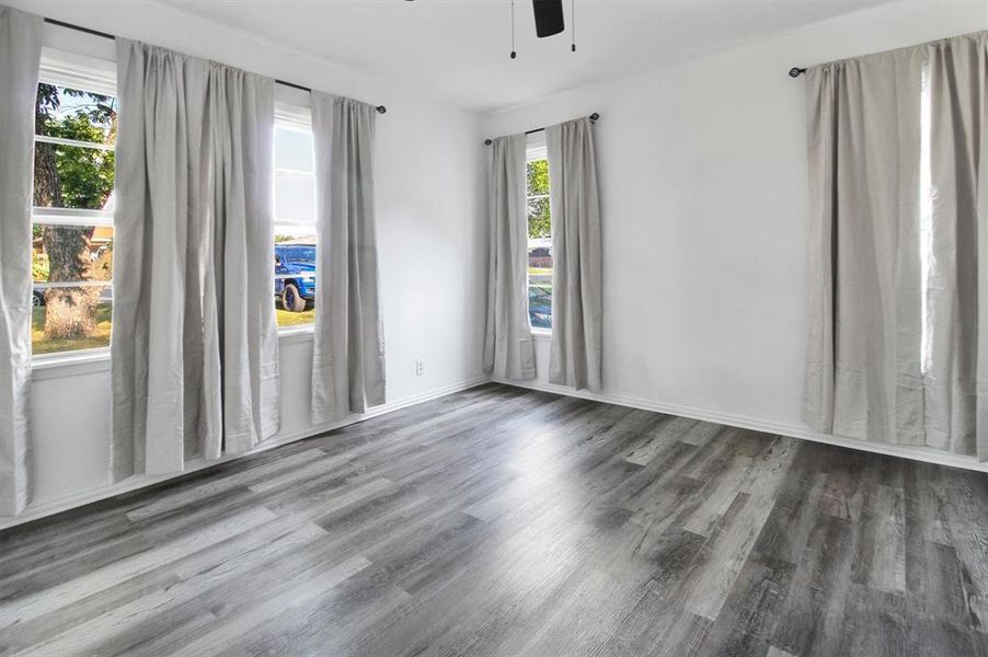 Unfurnished room featuring wood-type flooring and ceiling fan