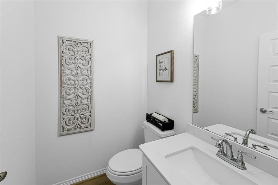 The brilliant half bath is conveniently located downstairs near the secondary bedroom and the staircase.