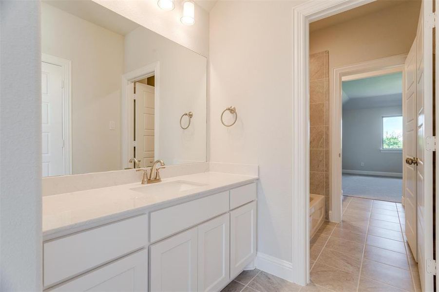 Bathroom featuring vanity and tile patterned floors