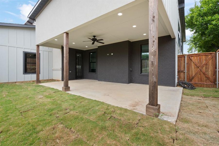 Back of house featuring a patio, a yard, and ceiling fan