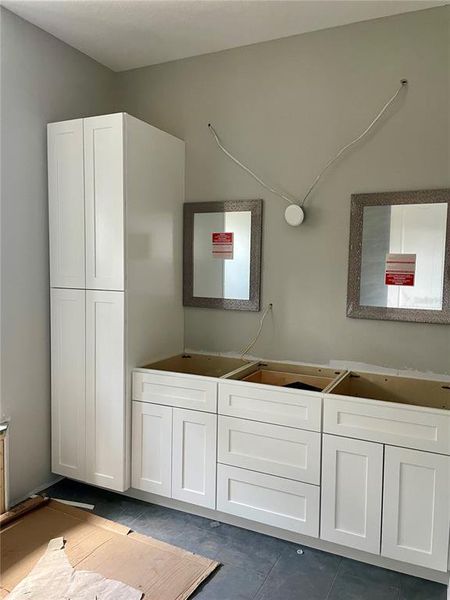Master bathroom with 2 recessed vanity cabinets as mirrors.  Double vanities.