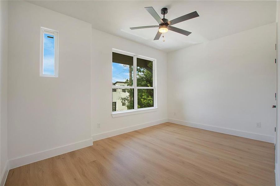 Spare room with ceiling fan and light hardwood / wood-style flooring