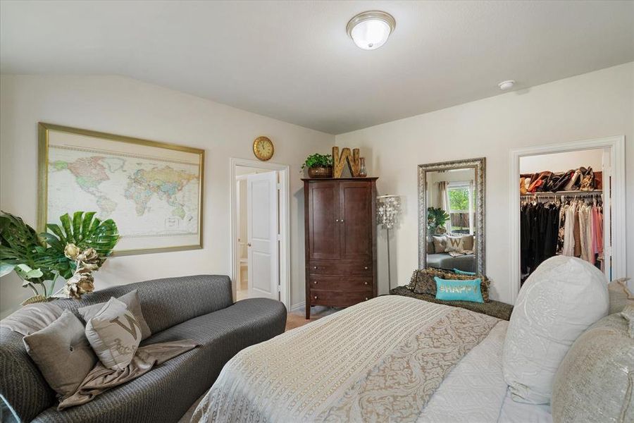 Bedroom featuring lofted ceiling, and walk in closet.