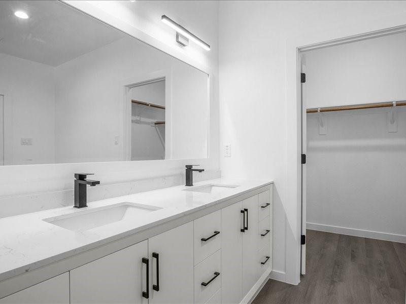 Bathroom featuring hardwood / wood-style floors and dual bowl vanity