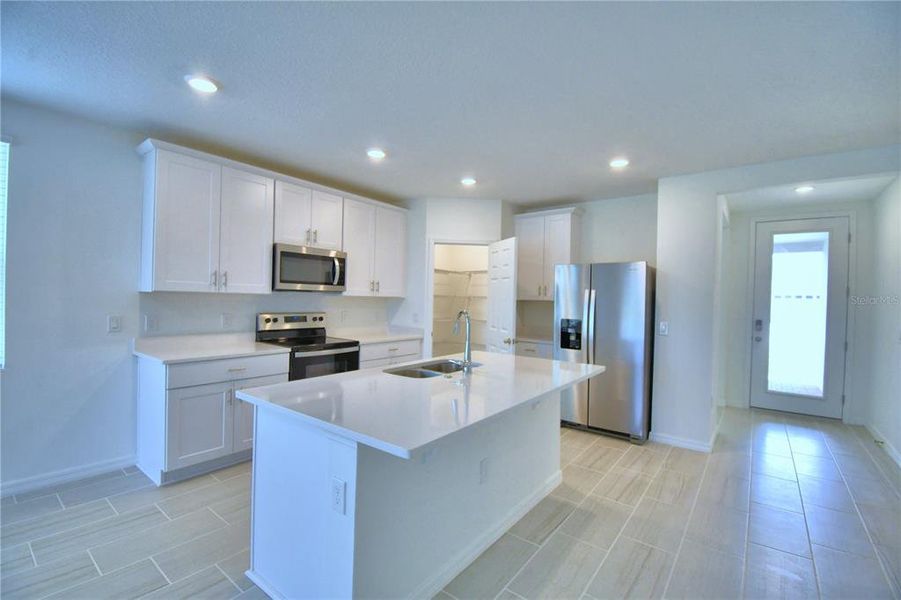 kitchen with quartz counter tops, crown molding