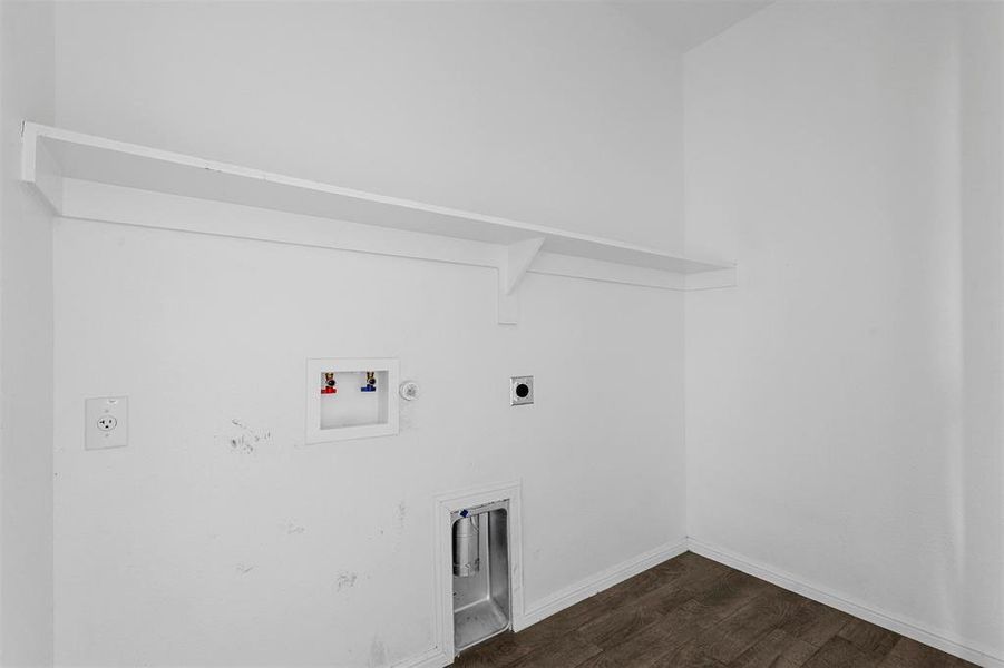 Washroom featuring dark wood-type flooring, gas dryer hookup, hookup for a washing machine, and hookup for an electric dryer