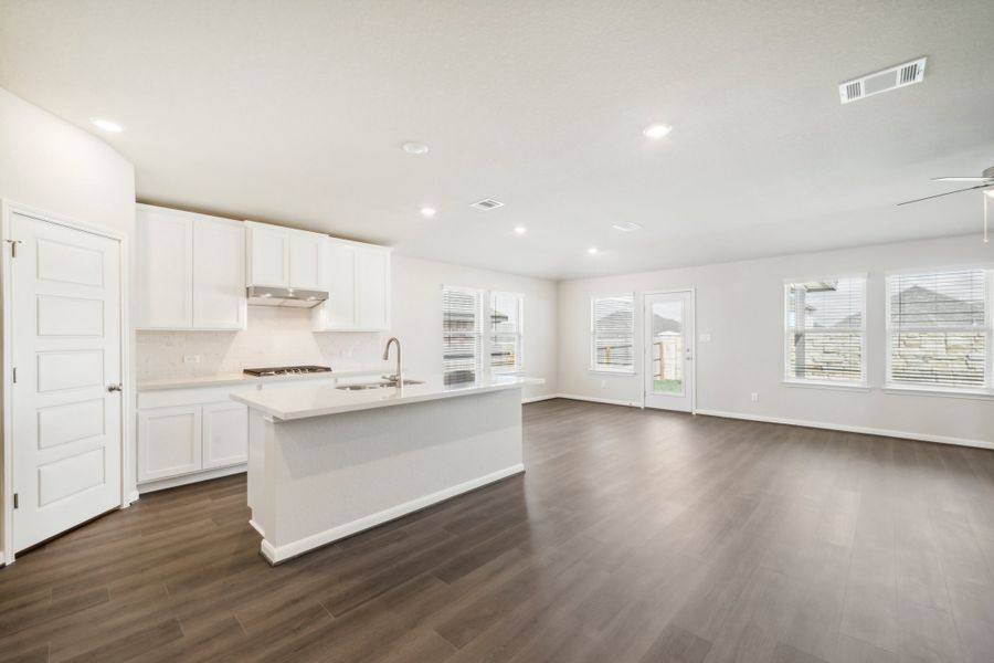 Kitchen, dining room, and living room in the Fitzhugh floorplan in a Meritage Homes community.