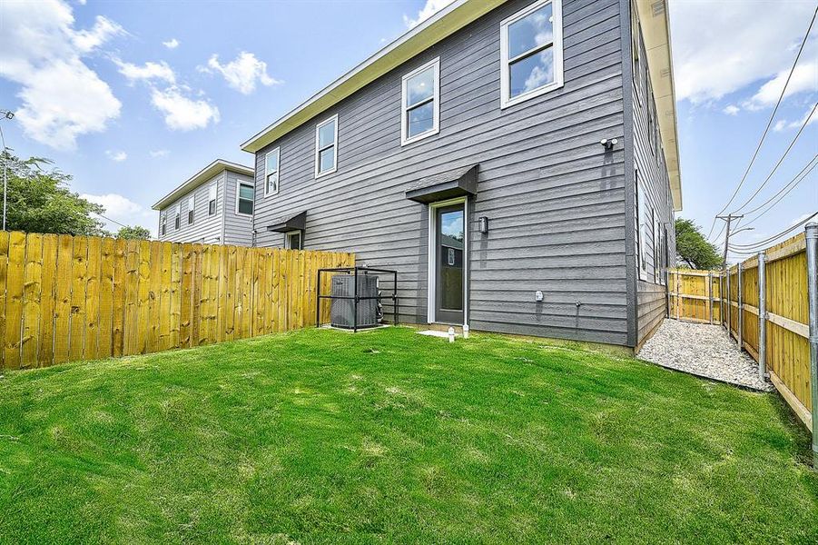 Rear view of house featuring a lawn