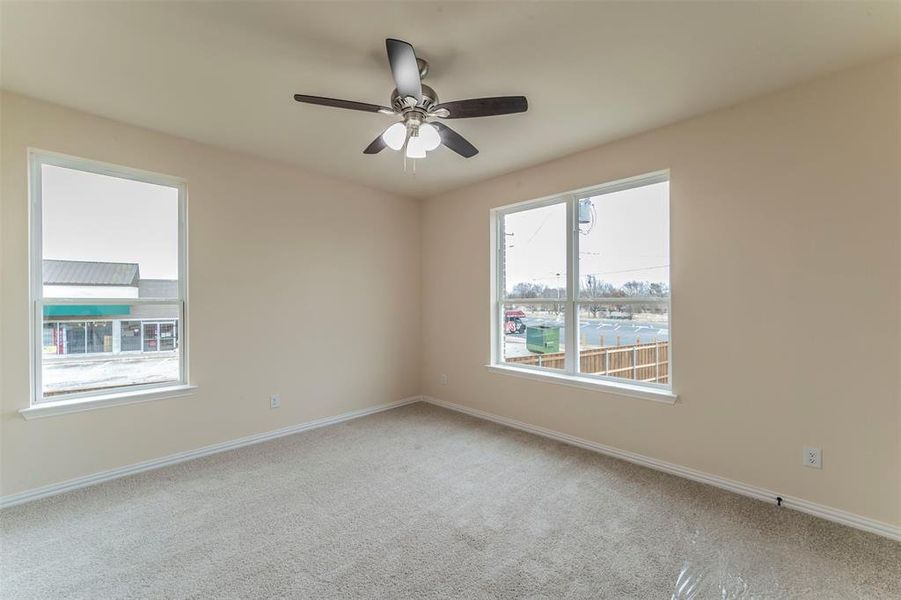 Empty room featuring carpet and ceiling fan