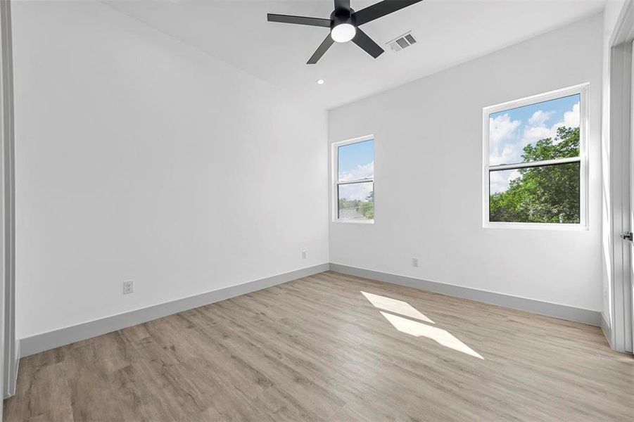Spare room with a healthy amount of sunlight and light wood-type flooring