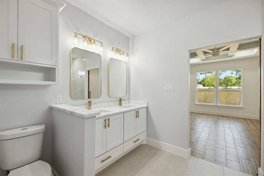 Bathroom featuring toilet, vanity, wood-type flooring, and ceiling fan