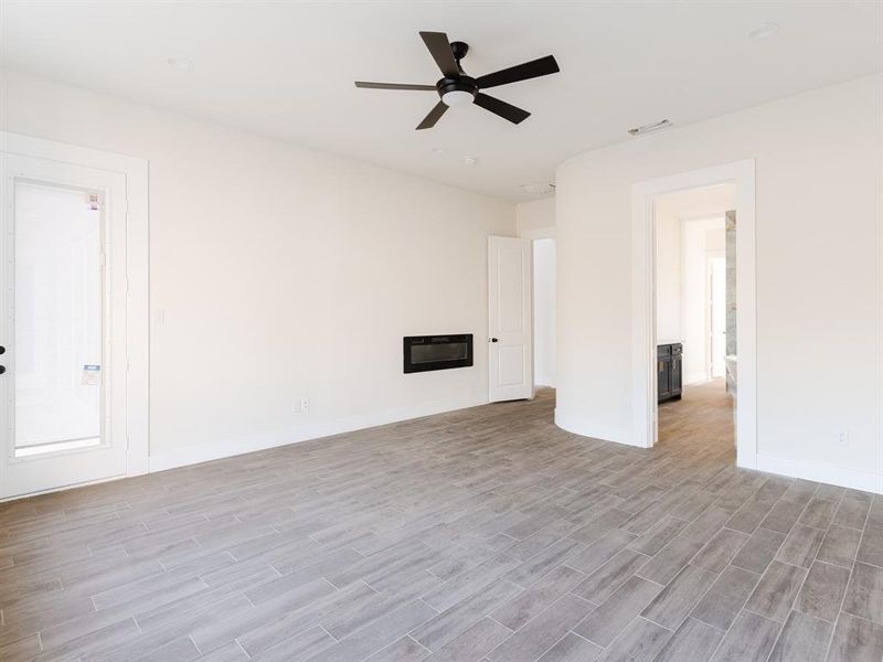 Primary Bedroom with ceiling fan and light hardwood / wood-style floors