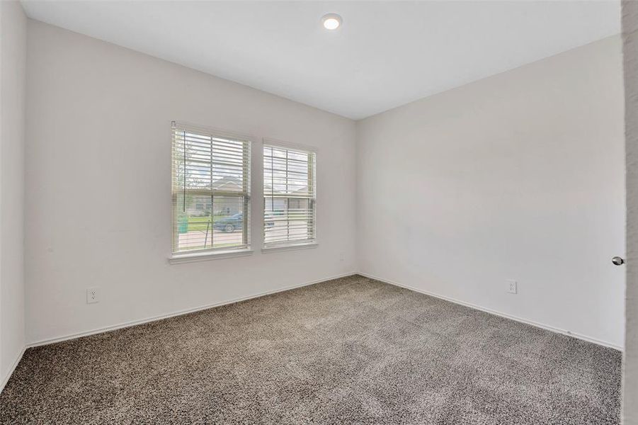 In addition to the primary bedroom, there is a secondary bedroom on the first floor and a secondary full bath.