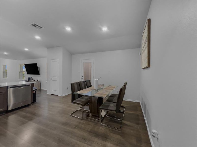 Dining area with dark wood-type flooring