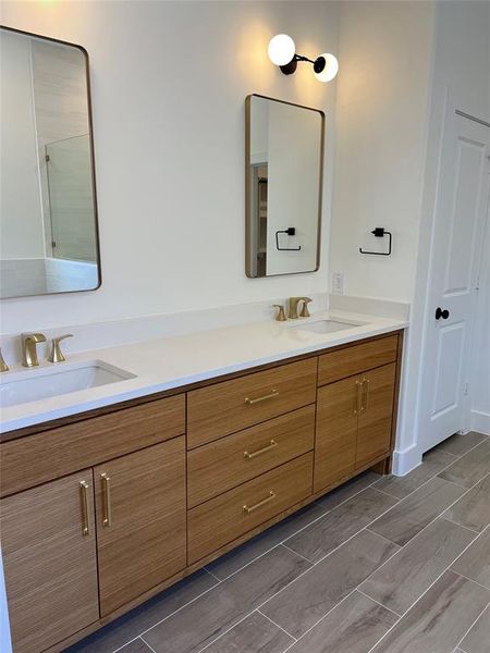 Bathroom featuring vanity and wood-type flooring