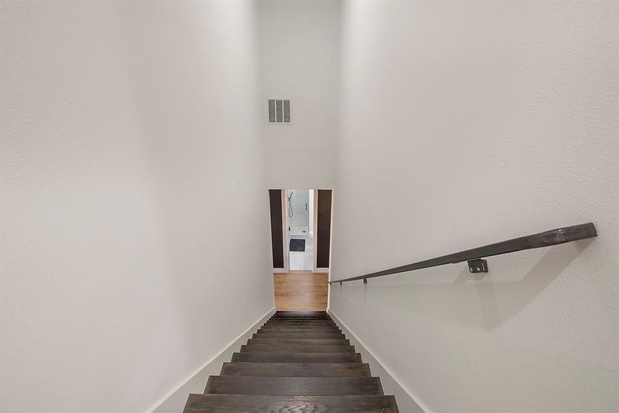 Stairs featuring hardwood / wood-style floors