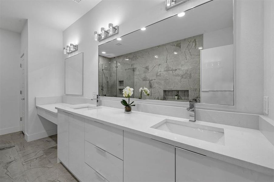 Bathroom featuring tile floors and duel vanities