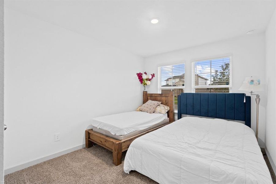 This secondary bedroom features ample natural light. Approximate Measurements: 14x10