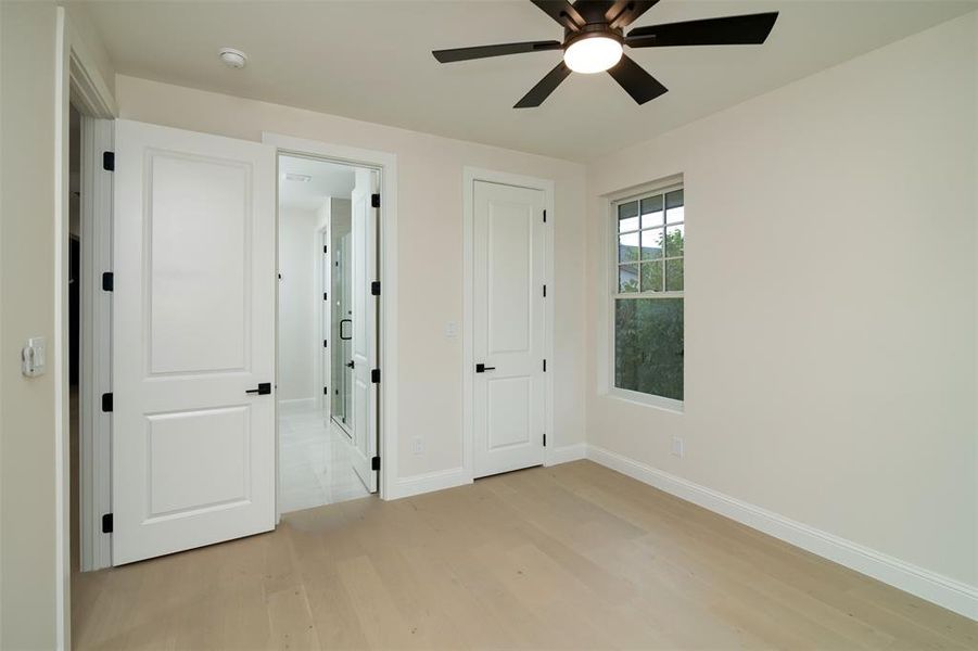 Unfurnished bedroom featuring ceiling fan and light wood-type flooring