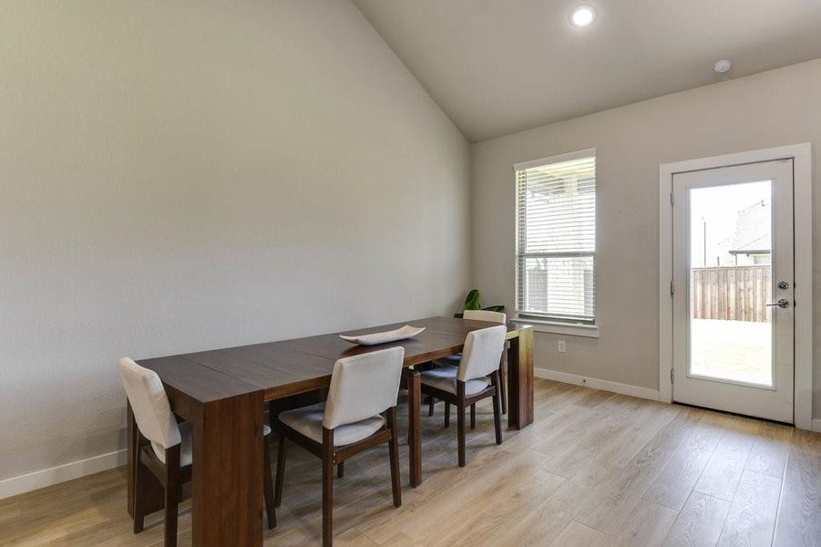 Lots of natural light in the dining area with a door that leads to the back covered patio.